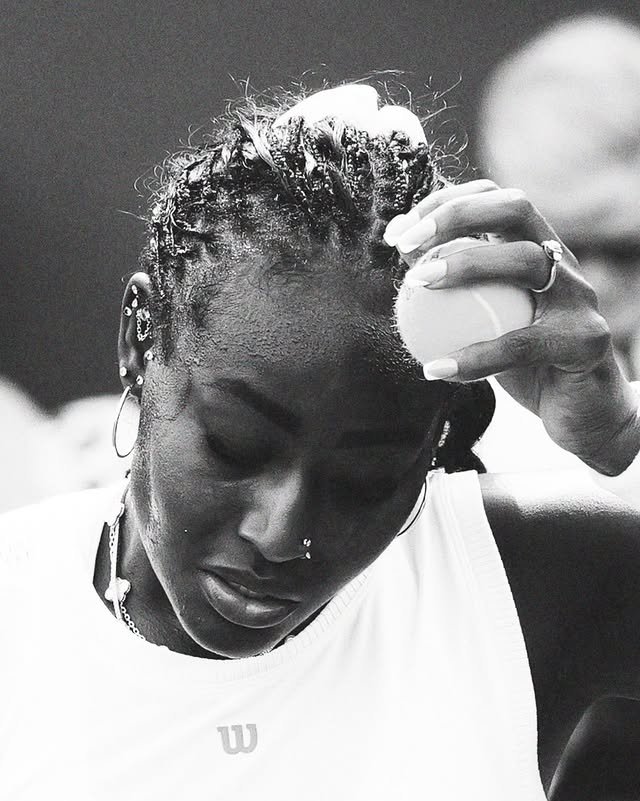 Black and white portrait of Alycia Parks holding a tennis ball to her head between points